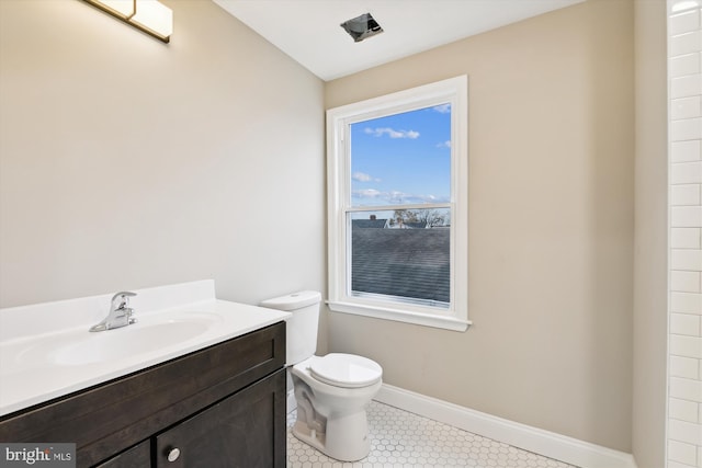 bathroom with tile patterned floors, vanity, and toilet