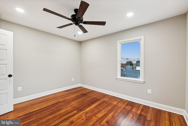 empty room featuring wood-type flooring and ceiling fan