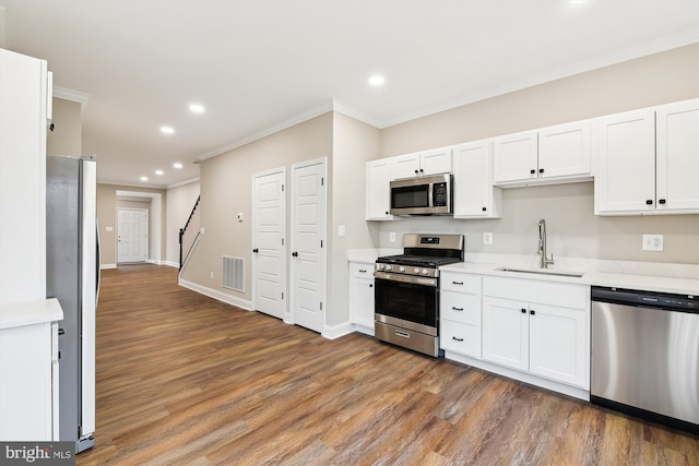 kitchen with white cabinets, stainless steel appliances, dark wood-type flooring, and sink