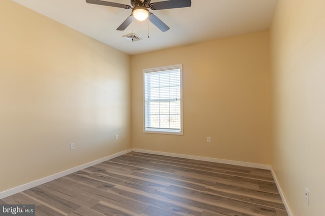 unfurnished room with dark hardwood / wood-style flooring and ceiling fan