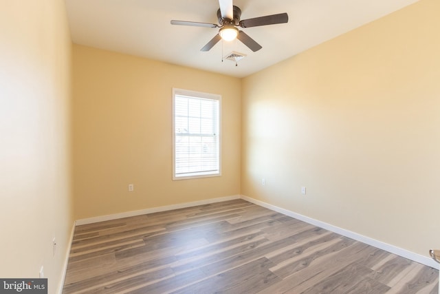 unfurnished room featuring hardwood / wood-style floors and ceiling fan