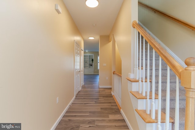 hall with wood-type flooring