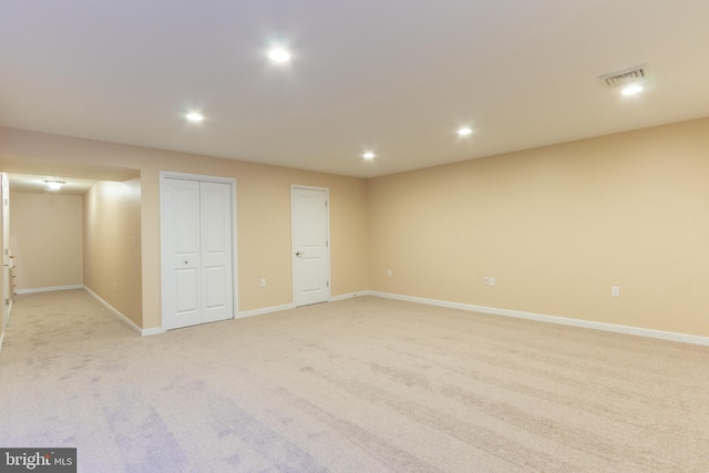 basement featuring light carpet