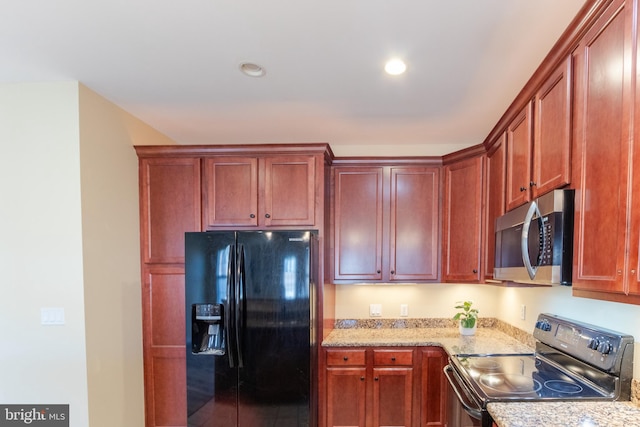 kitchen with light stone counters and appliances with stainless steel finishes