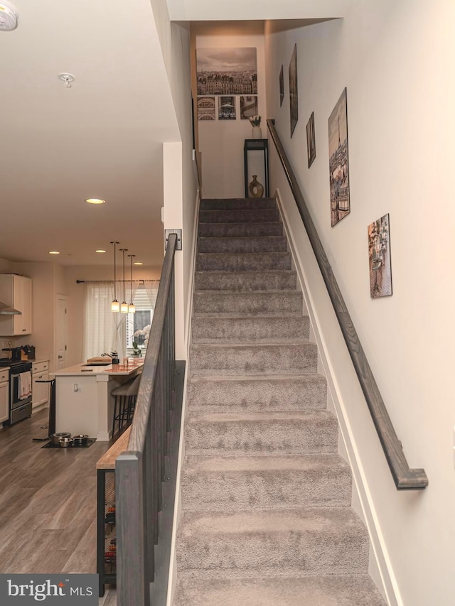 stairs featuring wood-type flooring