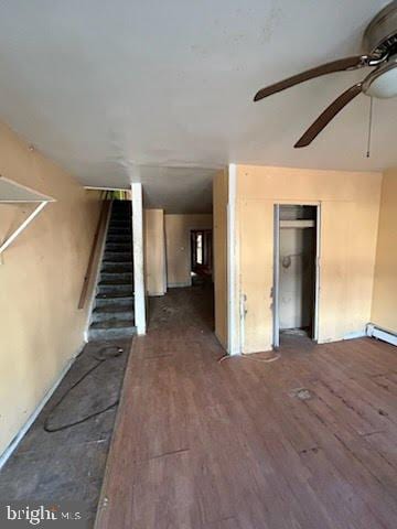 interior space with ceiling fan and dark wood-type flooring