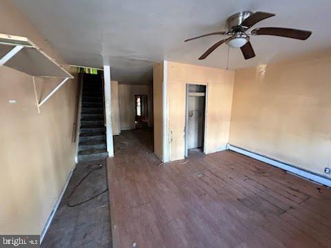 interior space with dark hardwood / wood-style floors and ceiling fan