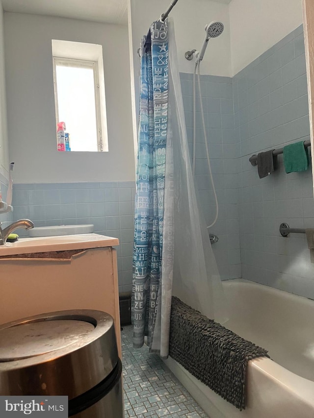 bathroom featuring tile walls and shower / bath combo