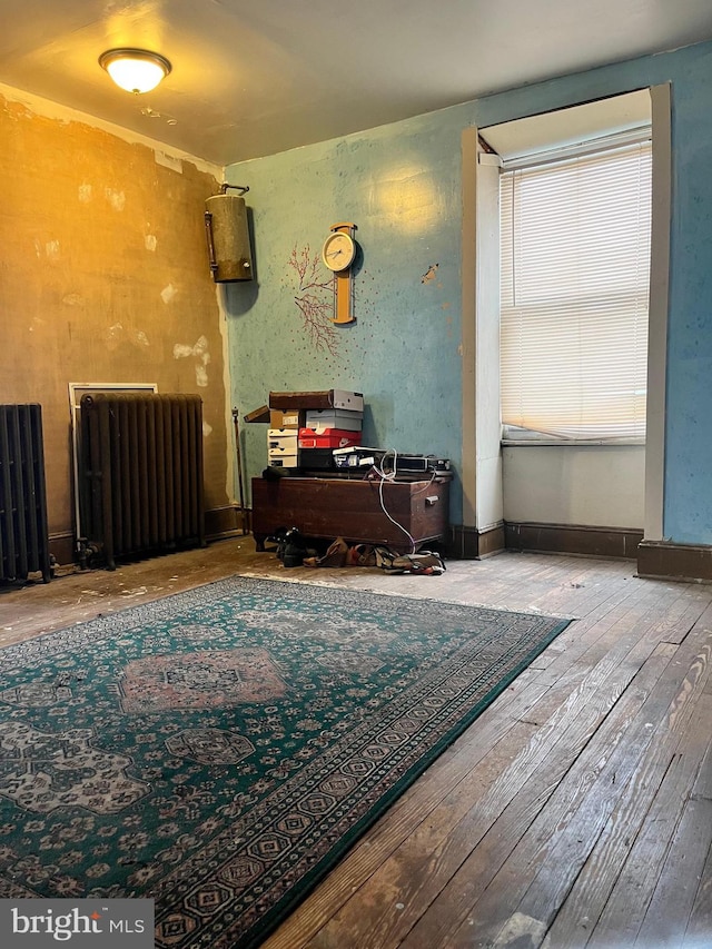 miscellaneous room featuring wood-type flooring and radiator heating unit