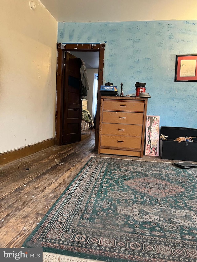 bedroom with dark hardwood / wood-style flooring