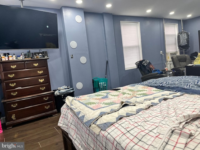 bedroom featuring dark hardwood / wood-style floors and cooling unit