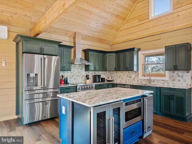 kitchen with wood walls, wall chimney exhaust hood, stainless steel appliances, and dark hardwood / wood-style floors