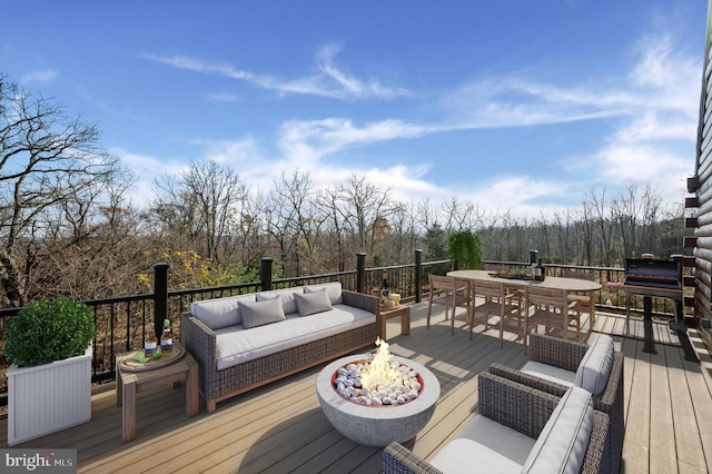 deck with an outdoor living space with a fire pit