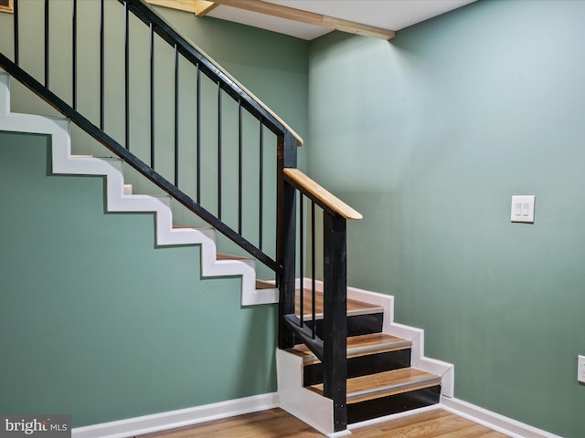 stairs with wood-type flooring