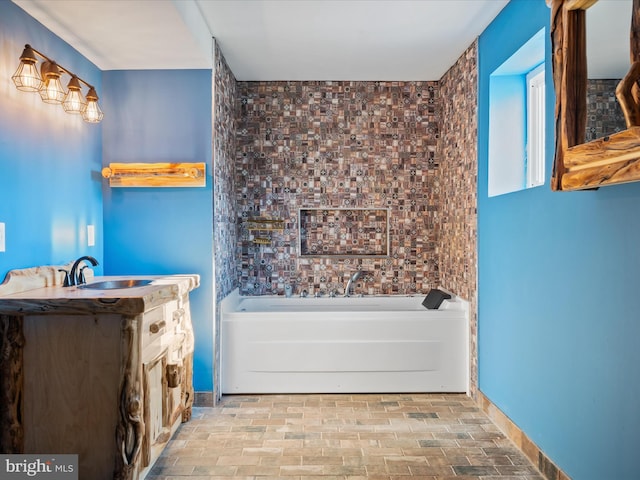 bathroom with vanity and a bath