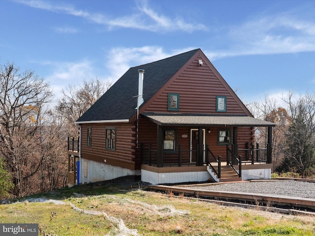 log-style house with a porch