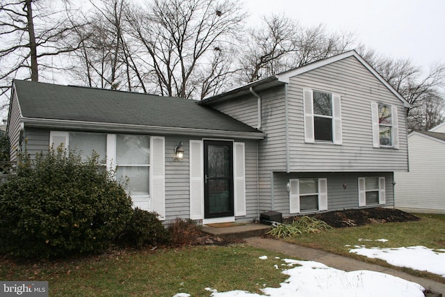 tri-level home with a front yard