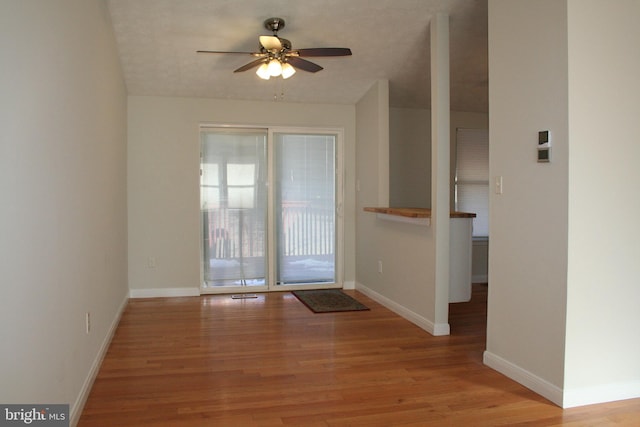 doorway to outside featuring ceiling fan and light wood-type flooring