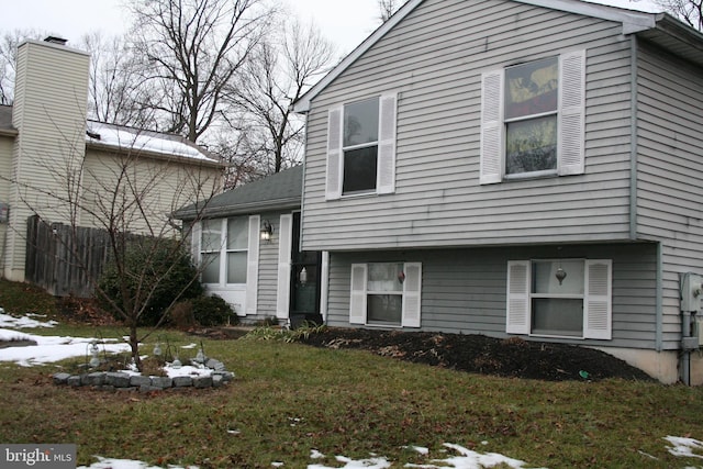 split level home featuring a yard