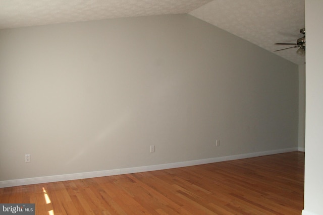 bonus room with ceiling fan, wood-type flooring, vaulted ceiling, and a textured ceiling