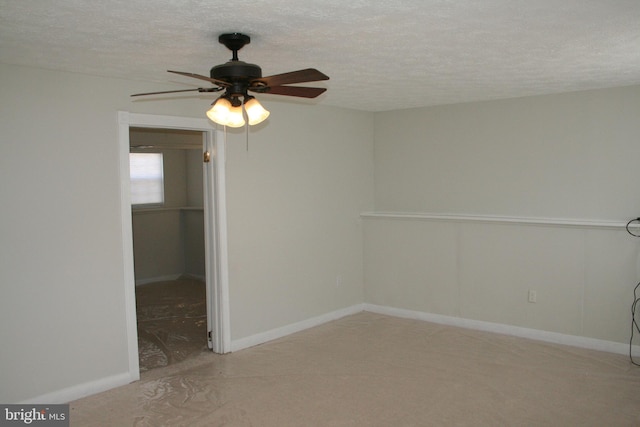 spare room featuring ceiling fan and a textured ceiling