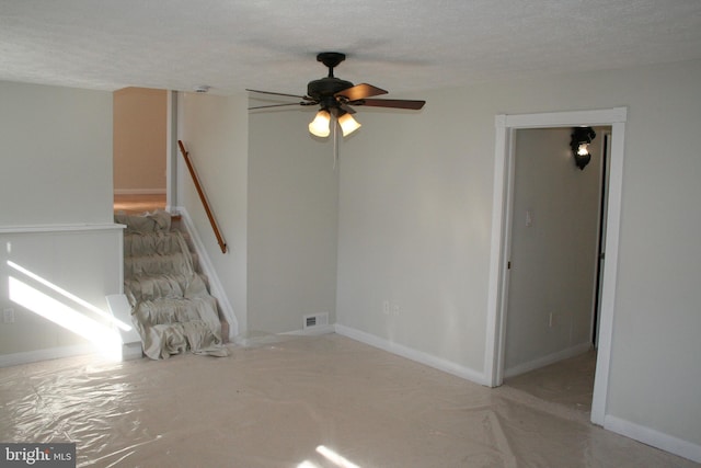 spare room featuring ceiling fan and a textured ceiling