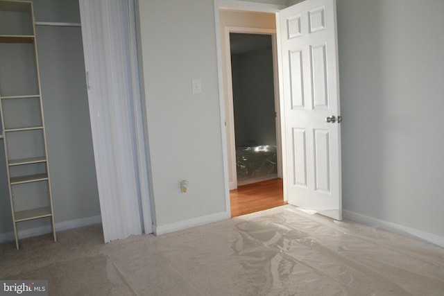 unfurnished bedroom with light colored carpet