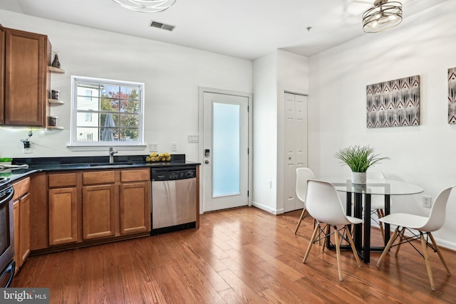 kitchen featuring dishwasher, dark hardwood / wood-style floors, and sink