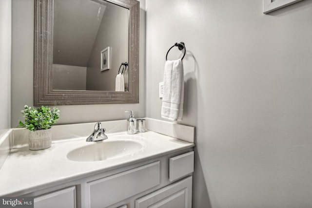 bathroom with vanity and vaulted ceiling