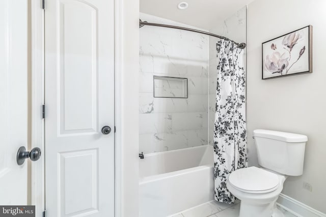 bathroom featuring shower / bath combo and toilet