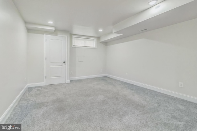 basement featuring light colored carpet