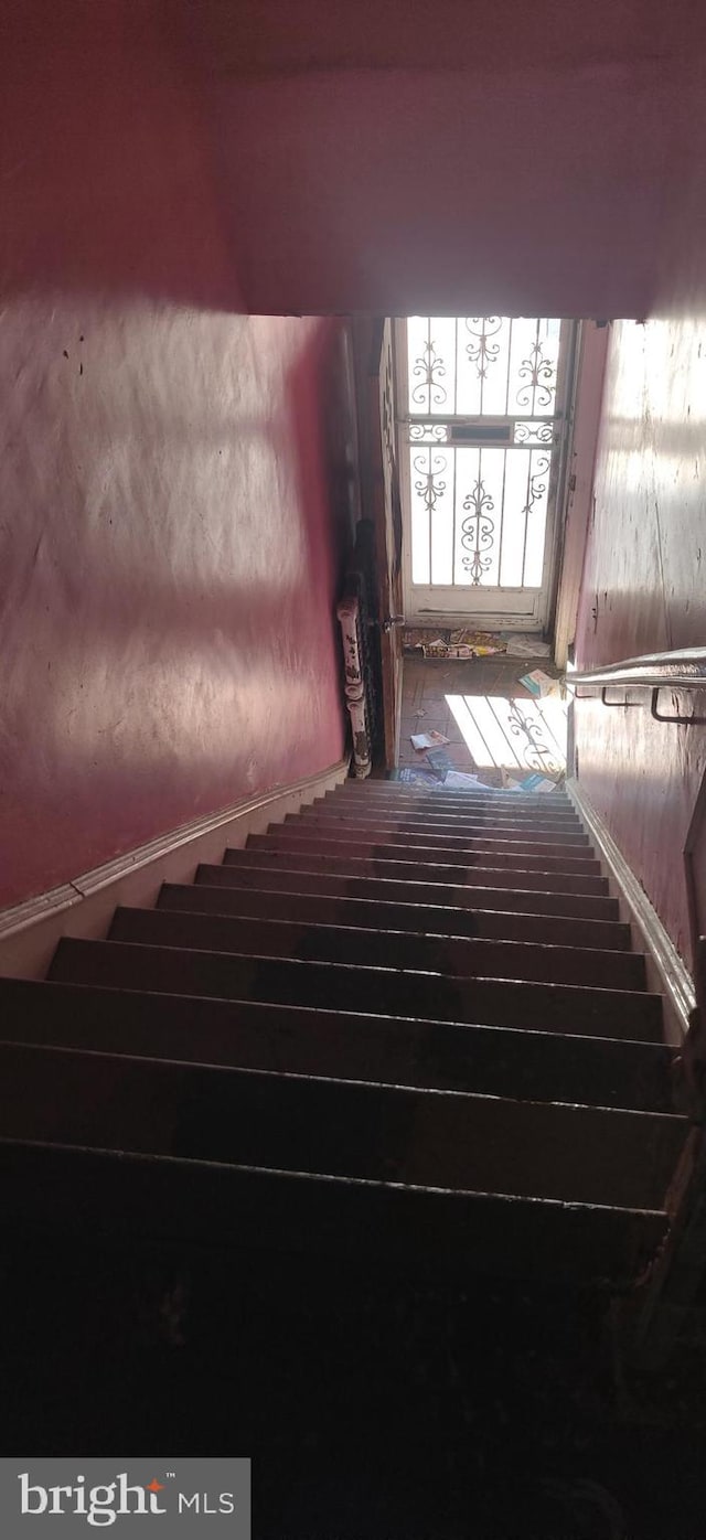 stairway with hardwood / wood-style floors