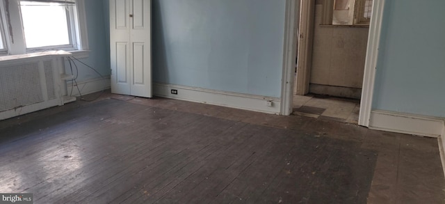 empty room with dark wood-type flooring