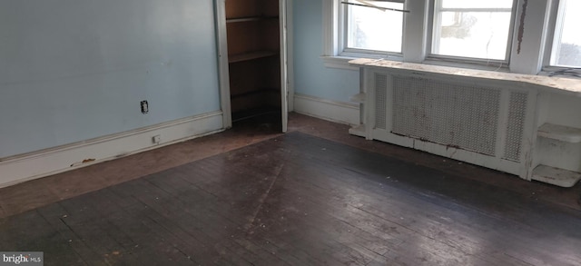 interior space featuring dark wood-type flooring and radiator