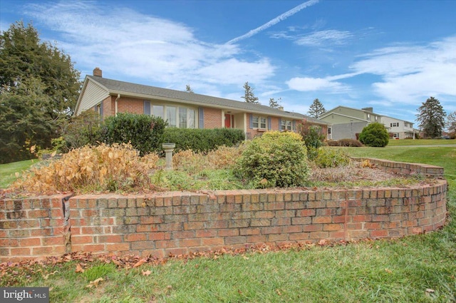 ranch-style home with a front lawn