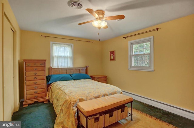 carpeted bedroom featuring ceiling fan and a baseboard heating unit