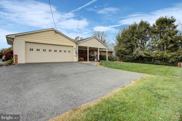 single story home featuring a garage and a front lawn