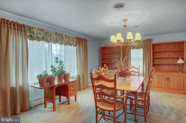 carpeted dining room featuring a chandelier