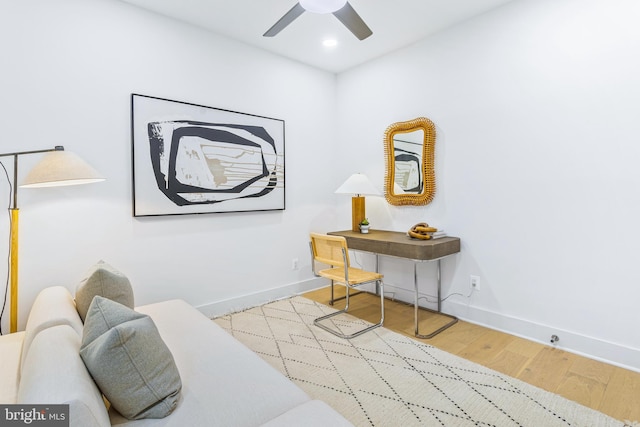 living area featuring ceiling fan and light hardwood / wood-style floors