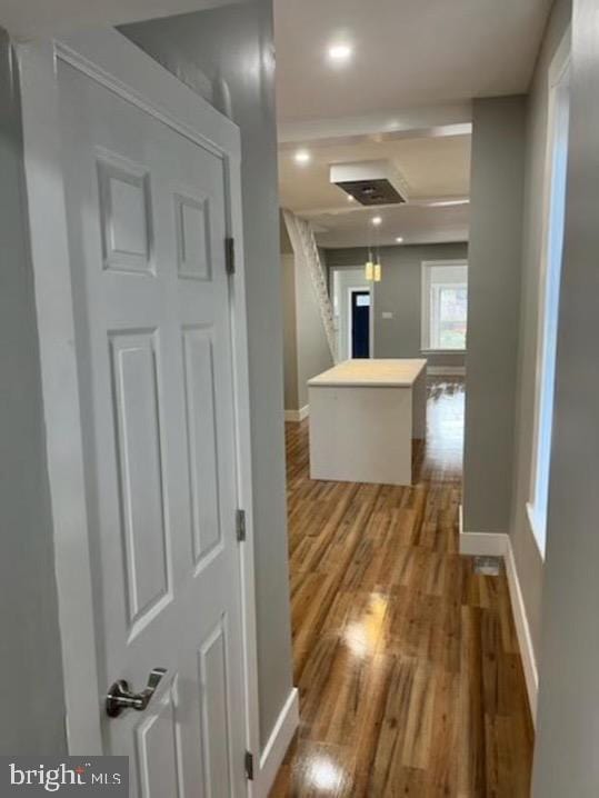 hall featuring baseboards and wood finished floors