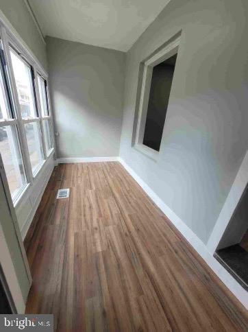213 N Ramsey St, Philadelphia, PA 19139 - empty room with wood finished floors, visible vents, and baseboards