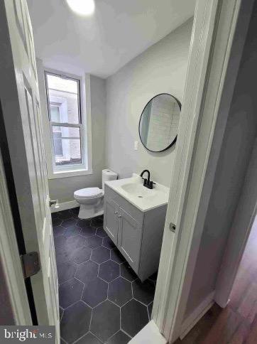 213 N Ramsey St, Philadelphia, PA 19139 - bathroom featuring toilet, tile patterned flooring, and vanity