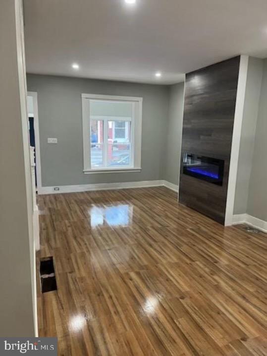 213 N Ramsey St, Philadelphia, PA 19139 - unfurnished living room with recessed lighting, a large fireplace, baseboards, and wood finished floors
