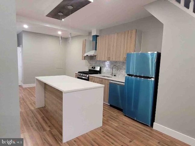 213 N Ramsey St, Philadelphia, PA 19139 - kitchen featuring dishwashing machine, freestanding refrigerator, stainless steel stove, wall chimney range hood, and a sink