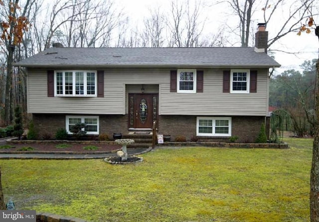 bi-level home with a front lawn