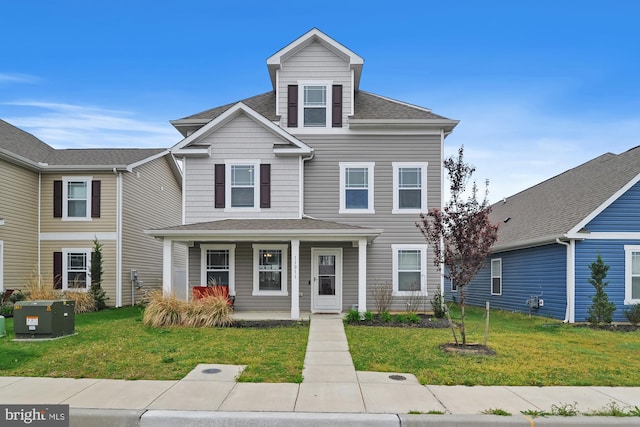 view of front of house featuring a front yard and covered porch