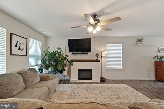 living room with dark hardwood / wood-style flooring and ceiling fan