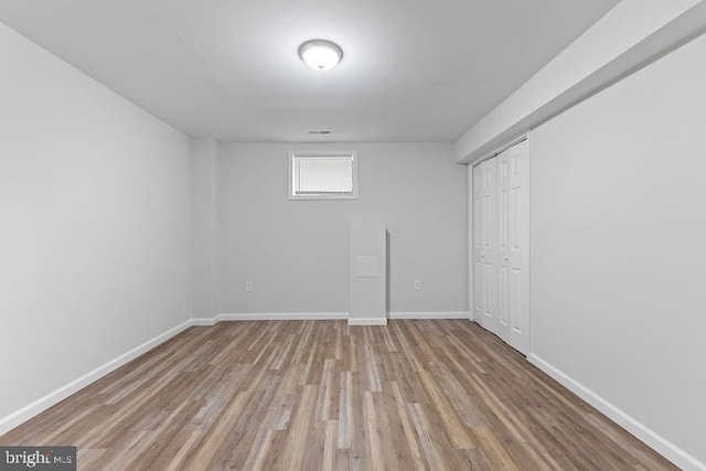 basement with light hardwood / wood-style floors