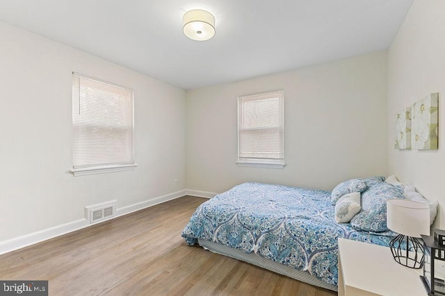 bedroom with hardwood / wood-style floors