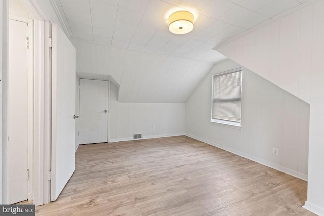 bonus room with light hardwood / wood-style flooring and lofted ceiling